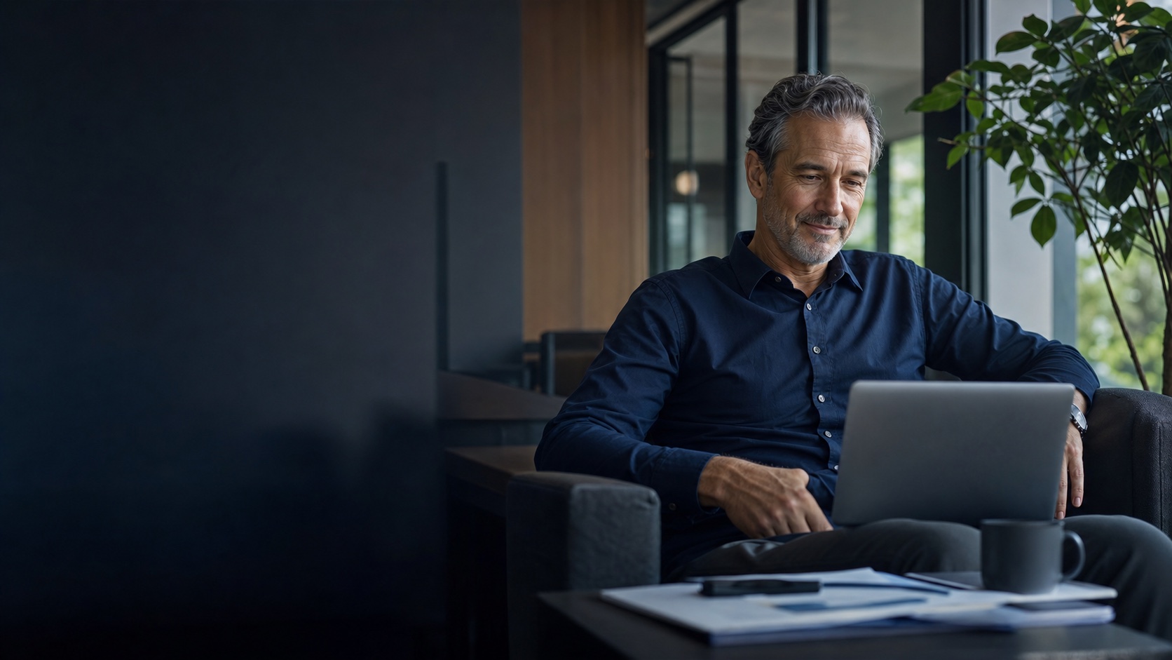Business owner calmly reviewing a restructuring plan on a laptop