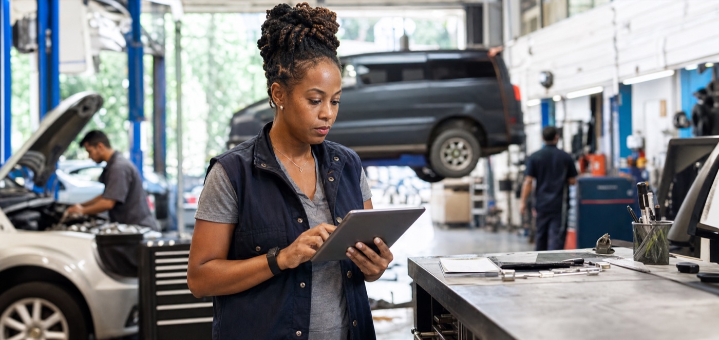Auto repair shop owner monitoring revenue during the workday